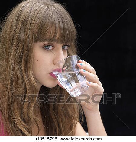 Stock Photo - Young woman drinking water. Fotosearch