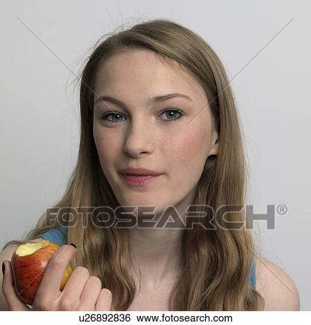 young woman eating an apple View Large Photo Image Stock Photograph - young woman eating an apple. Fotosearch