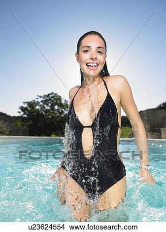 young woman jumping out of water View Large Photo Image Picture - young woman jumping out of water. Fotosearch