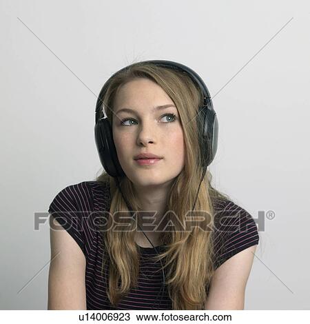 young woman listening to music View Large Photo Image Stock Image - young woman listening to music. Fotosearch