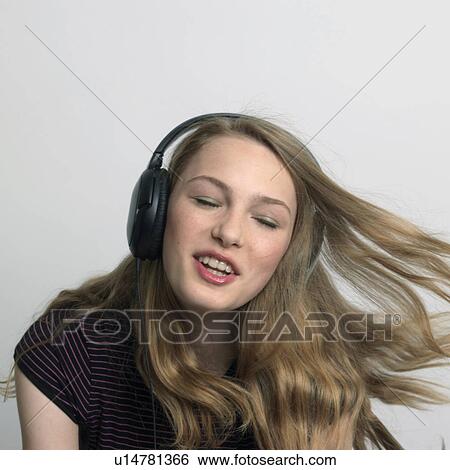 young woman listening to music View Large Photo Image Stock Photograph - young woman listening to music. Fotosearch