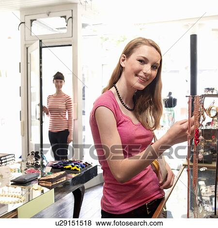 young woman looking at jewelry View Large Photo Image Stock Photo - young woman looking at jewelry. Fotosearch