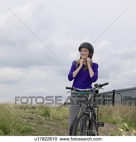 Stock Image - Young woman with bicycle. Fotosearch