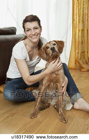 Stock Image - Young woman with dog. Fotosearch