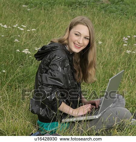 young woman with laptop in park View Large Photo Image Stock Image - young woman with laptop in park. Fotosearch