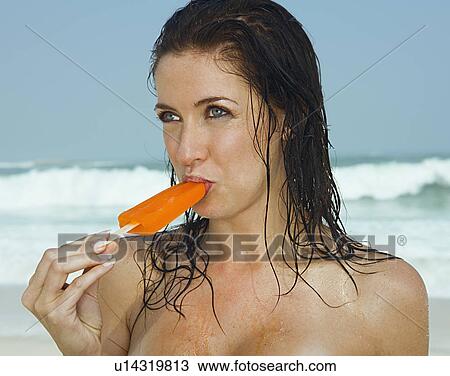 Young women eating a ice cream View Large Photo Image Stock Image - Young women eating a ice cream. Fotosearch