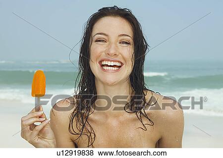 Young women eating a ice cream View Large Photo Image Stock Photo - Young women eating a ice cream. Fotosearch