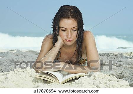 Young Women on Beach reading a book View Large Photo Image Picture - Young Women on Beach reading a book. Fotosearch