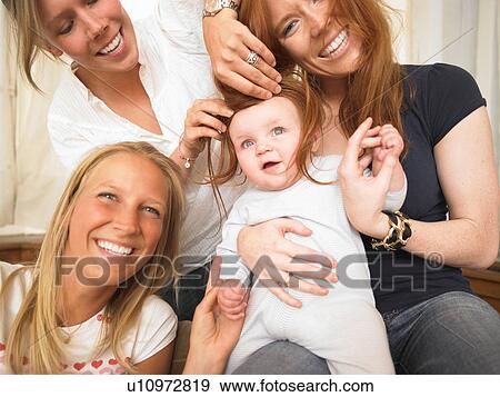 young women playing with baby View Large Photo Image Stock Photo - young women playing with baby. Fotosearch