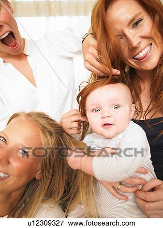 young women playing with baby View Large Photo Image Stock Photo - young women playing with baby. Fotosearch