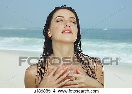 Young women with ice cubes on her chest View Large Photo Image Picture - Young women with ice cubes on her chest. Fotosearch