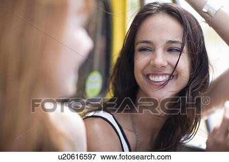 2 Girl friends smiling at each other View Large Photo Image Stock Photo - 2 Girl friends smiling at each other. Fotosearch