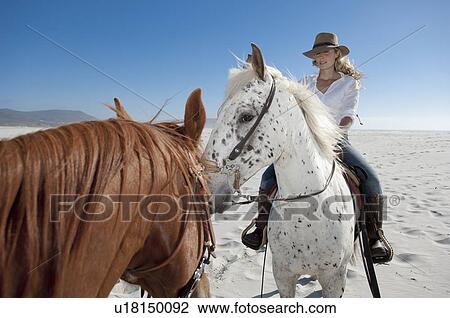 2 people riding horses on the beach View Large Photo Image Stock Image - 2 people riding horses on the beach. Fotosearch
