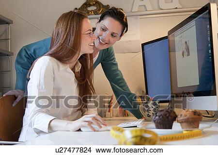 Picture - 2 Woman working at the computer. Fotosearch