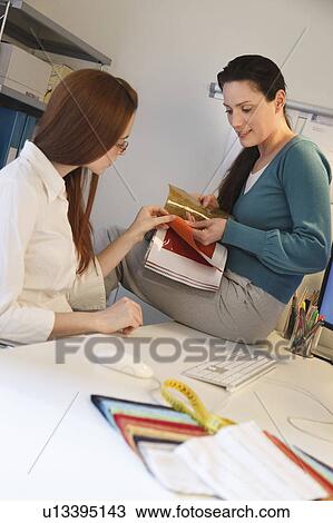 2 women looking at fabric samples View Large Photo Image Stock Image - 2 women looking at fabric samples. Fotosearch