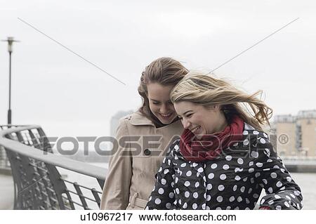 2 young windswept women laughing View Large Photo Image Stock Photo - 2 young windswept women laughing. Fotosearch
