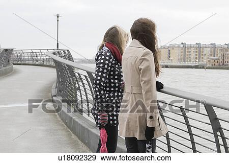 2 young women looking at river View Large Photo Image Stock Photo - 2 young women looking at river. Fotosearch