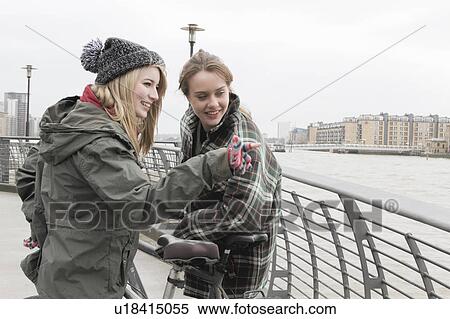 2 young women with push bikes View Large Photo Image Stock Photography - 2 young women with push bikes. Fotosearch