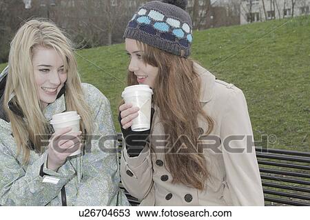 2 young women with take away cups View Large Photo Image Stock Image - 2 young women with take away cups. Fotosearch