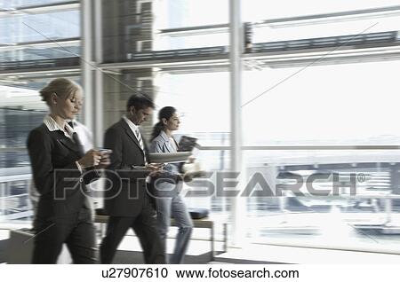 3 buisness people walking downa corridor View Large Photo Image Stock Image - 3 buisness people walking downa corridor. Fotosearch