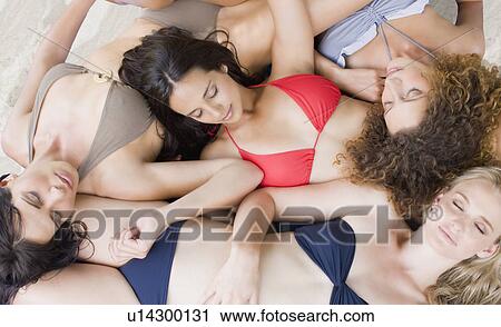 Stock Image -  4 girlfriends sunbathing. Fotosearch