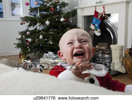 A baby crying at Christmas View Large Photo Image Stock Photograph - A baby crying at Christmas. Fotosearch