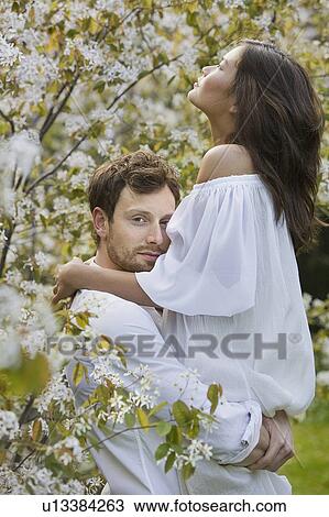 A couple hugging in the park View Large Photo Image Stock Image - A couple hugging in the park. Fotosearch