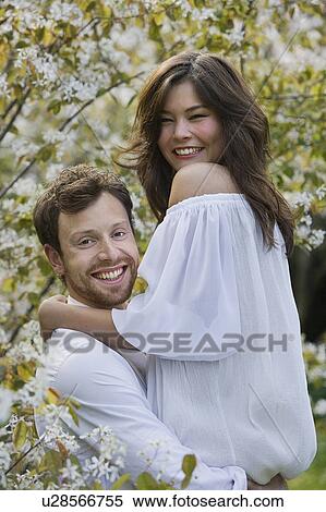 A couple hugging in the park View Large Photo Image Stock Photography - A couple hugging in the park. Fotosearch