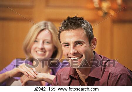 Stock Photography - A couple of course mates smiling. Fotosearch