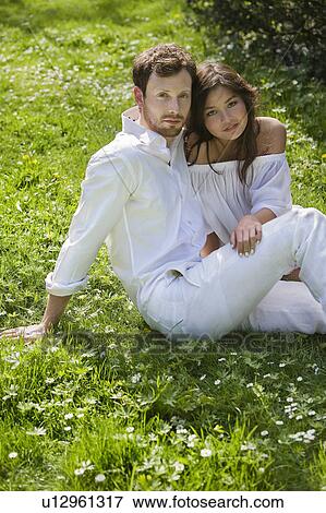 A couple sitting in the park View Large Photo Image Stock Photo - A couple sitting in the park. Fotosearch