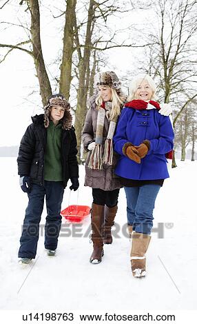 A family out for a walk in the snow View Large Photo Image Stock Image - A family out for a walk in the snow. Fotosearch