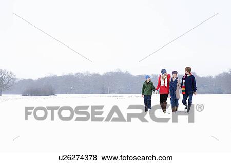 Stock Photo - A family walking in the snow. Fotosearch