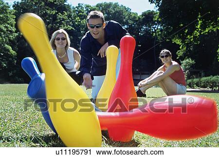 A group of friends playing skittles View Large Photo Image Stock Image - A group of friends playing skittles. Fotosearch