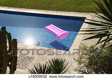 Stock Image - A Lilo floating in a pool. Fotosearch