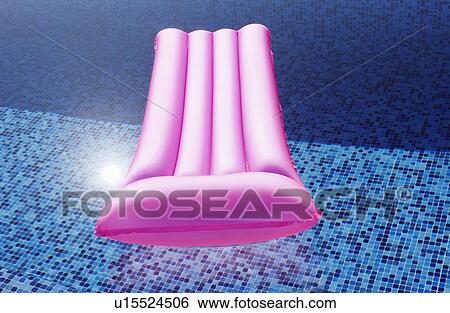 Stock Photograph - A Lilo floating in a pool. Fotosearch