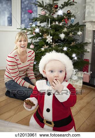 A mother and her baby at Christmas View Large Photo Image Stock Image - A mother and her baby at Christmas. Fotosearch
