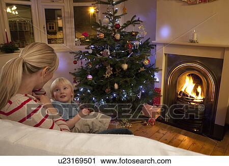 A mother and son by the Christmas tree View Large Photo Image Stock Image - A mother and son by the Christmas tree. Fotosearch