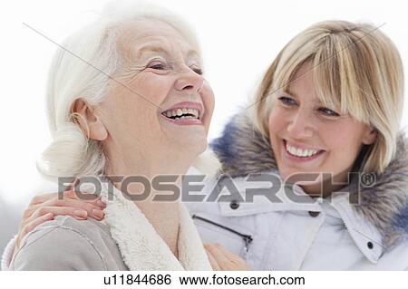 Stock Photograph - A portrait of two ladies in the snow. Fotosearch