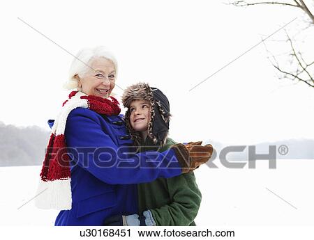 A senior female and a boy in the snow View Large Photo Image Stock Image - A senior female and a boy in the snow. Fotosearch