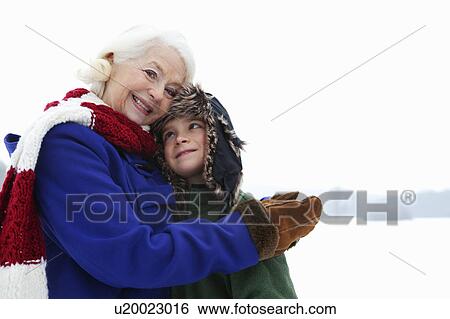A senior female and a boy in the snow View Large Photo Image Stock Photograph - A senior female and a boy in the snow. Fotosearch