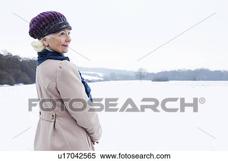 A senior female in a snowy landscape View Large Photo Image Stock Photography - A senior female in a snowy landscape. Fotosearch