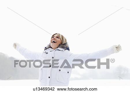 A woman arms outstretched in the snow View Large Photo Image Stock Image - A woman arms outstretched in the snow. Fotosearch