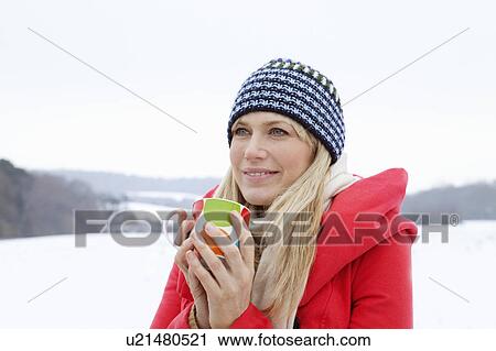 A woman with a hot drink in the snow View Large Photo Image Stock Image - A woman with a hot drink in the snow. Fotosearch