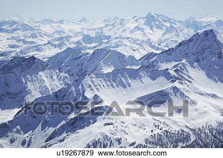 Stock Photo - Aerial view of snow covered mountains. Fotosearch