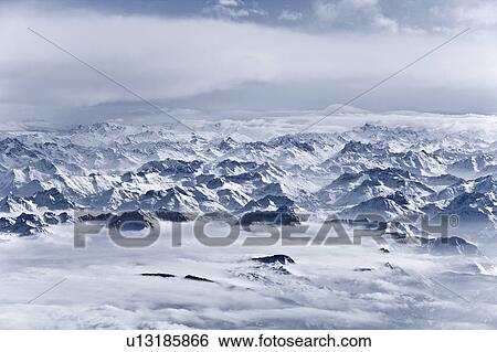 Aerial view of snow covered mountains View Large Photo Image Stock Photograph - Aerial view of snow covered mountains. Fotosearch