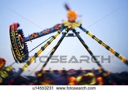 Stock Image - Amusement park ride against blue sky. Fotosearch