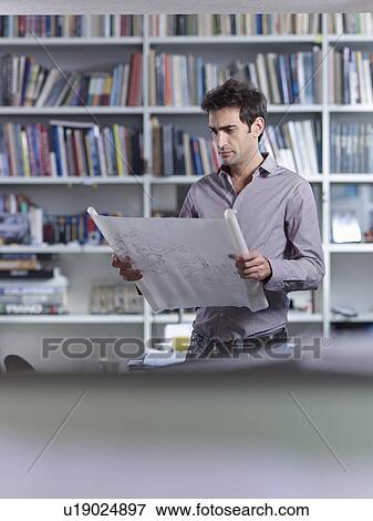 Architect concentration on plans View Large Photo Image Stock Photo - Architect concentration on plans. Fotosearch