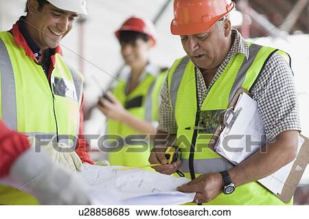 Architect explaining construction plans View Large Photo Image Stock Photography - Architect explaining construction plans. Fotosearch