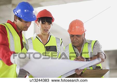 Architect showing construction plans View Large Photo Image Stock Image - Architect showing construction plans. Fotosearch
