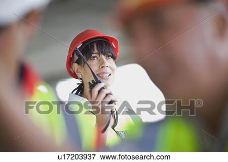 Architect speaking into walkie-talkie View Large Photo Image Stock Photo - Architect speaking into walkie-talkie. Fotosearch